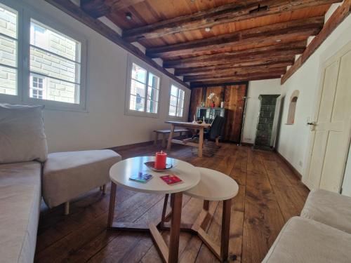 a living room with a couch and a table at Historic cozy flat in Citycenter by Lake Constance in Überlingen