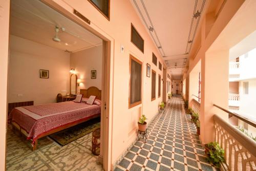 a corridor of a room with a bed in it at Hotel Arya Niwas in Jaipur