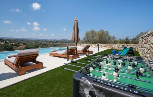 a pool table with a game of billiards at Calmo Luxury Villas, with Pool Tranquil Elegance, By ThinkVilla in Lamerianá