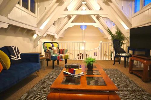 a living room with a blue couch and a table at Seaside Chapel Escape Character Home Near Beach Sleep 5 in Great Yarmouth