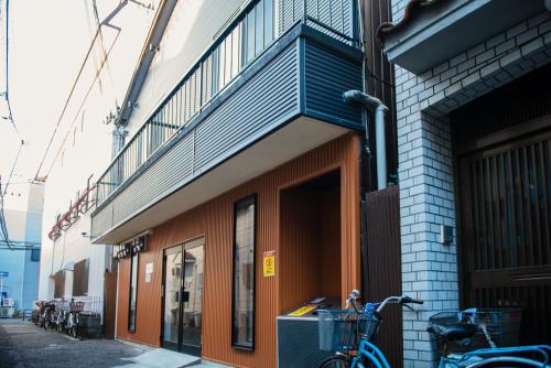 a bike parked on the side of a building at Tycq Nagahashi TYレジデンス in Osaka