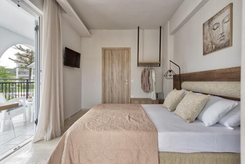 a bedroom with a bed and a balcony at Sofia - Yiota Studios & Apartments in Tsilivi