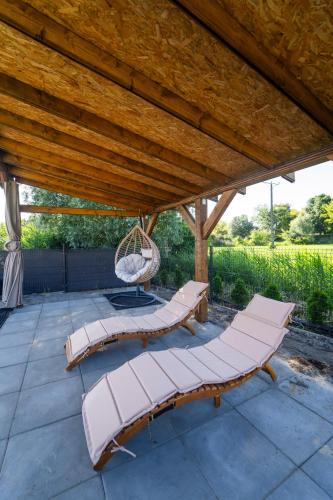 a patio with two chairs and a swing at Morze Tu in Stegna