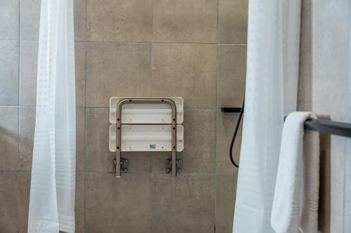 a towel dispenser on the wall of a bathroom at ATKV Goudini Spa in Rawsonville
