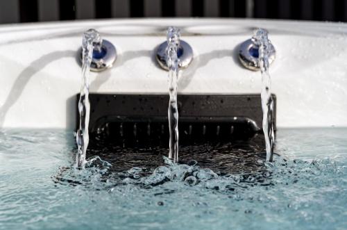 two water faucets in a pool of water at Onyx Hotel in St Julian's
