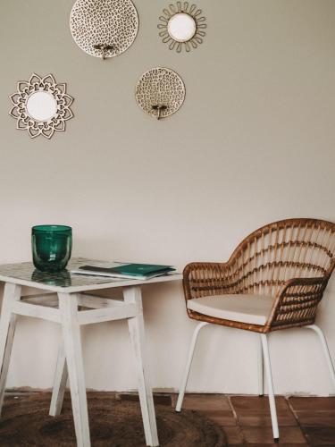 a table and a chair next to a table at Ferienhaus Faakersee Hideaway am See in Faak am See