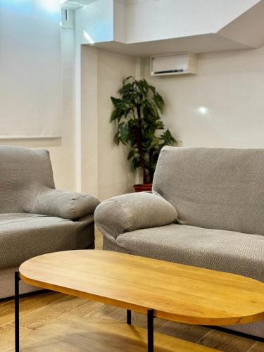 a living room with two couches and a coffee table at Residencia Mediterraneo in San Vicente del Raspeig