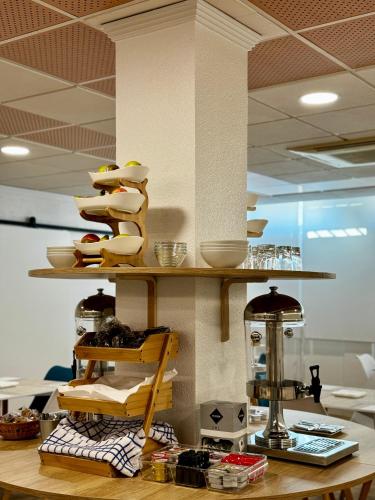 a kitchen with a counter with a shelf of food at Residencia Mediterraneo in San Vicente del Raspeig