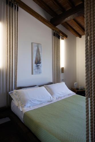 a bedroom with a bed with a picture of a boat at Di Colle in Colle - Agriturismo in Passignano sul Trasimeno