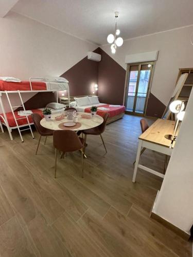 a room with a room with bunk beds and a table at B&B Elegance in Villa San Giovanni