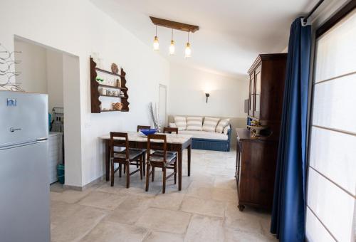 a kitchen and living room with a table and chairs at Di Colle in Colle - Agriturismo in Passignano sul Trasimeno