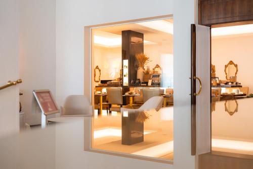 a view of a dining room through a glass door at Hotel Universal Terme in Abano Terme