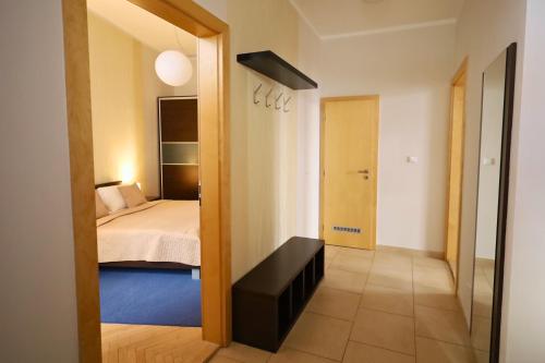 a room with a bed and a door to a bedroom at Rezidence Ostrovní in Prague
