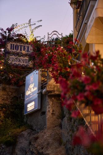 a sign for a hotel with flowers on a building at Hotel Villa Pandora in Maiori