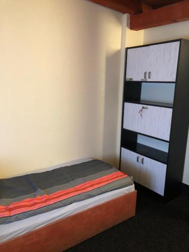 a small bedroom with a bed and a dresser at Penni panzió Kaposvár- répáspuszta in Kaposvár