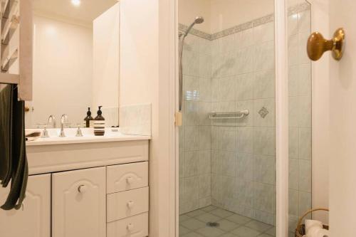 a bathroom with a shower and a sink at Peony Farm Green Cottage in Stanley