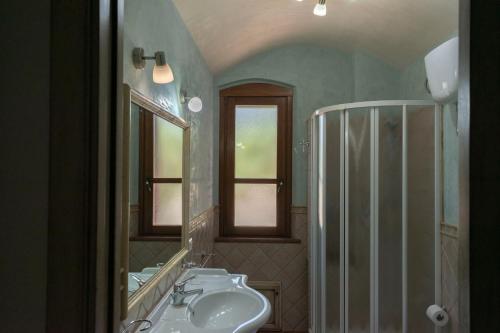 a bathroom with a sink and a mirror at Casa vacanze Tortoli' in Tortolì