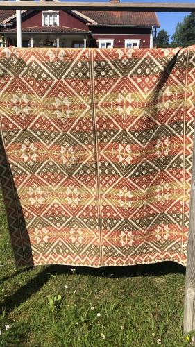 a quilt that is sitting in the grass at Långhedgården Bed & Breakfast in Alfta