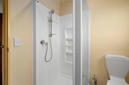 a bathroom with a shower and a toilet at Korimako Ridge - Lake Hawea Holiday Home in Lake Hawea