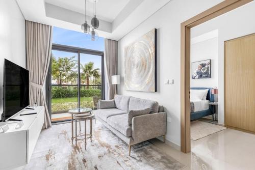 a living room with a couch and a tv and a bed at Goldbest - Aykon City 2bdr in Dubai