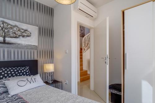 a bedroom with a bed and a wall at Vila Blanka in Martinšćica