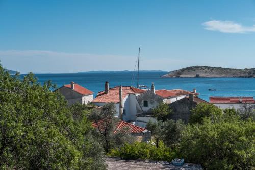 a group of houses with the ocean in the background at Vila Blanka in Martinšćica