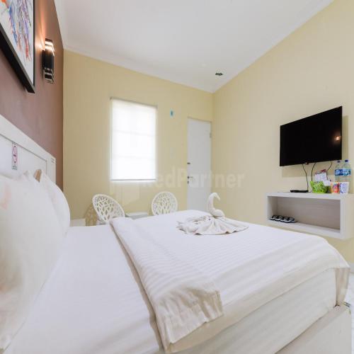 Ένα ή περισσότερα κρεβάτια σε δωμάτιο στο Hotel 78 Parapat Mitra RedDoorz