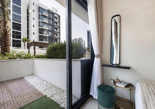 a balcony with a view of a building at 1BR Gem with Pool 15 Mins to Downtown Dubai in Dubai