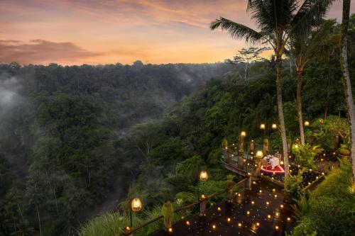 a group of lights on a mountain with a forest at Pramana Watu Kurung in Ubud
