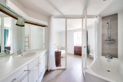 La salle de bains blanche est pourvue de 2 lavabos, d'une baignoire et d'une baignoire. dans l'établissement Nantes Mediathèque, grand T2 sous les toits, à Nantes