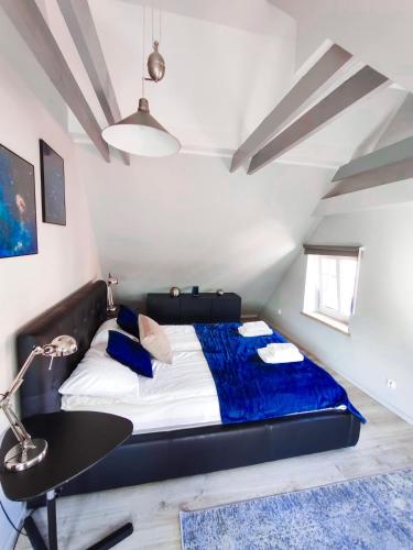 a bedroom with a black bed and a desk at Klimatyzowany z widokiem - zniżki do SPA - Astro by Rentoom in Toruń