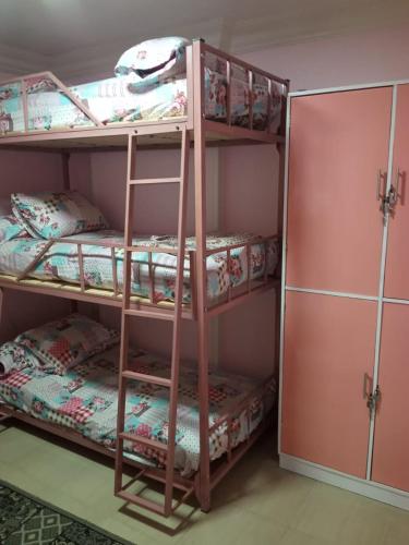 a bunk bed room with three bunk beds in it at Youth Palace Hostel هوستل قصر الشباب in Alexandria