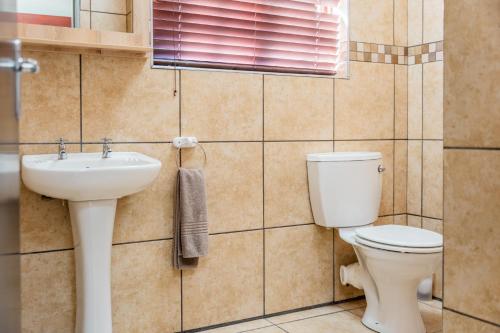 a bathroom with a toilet and a sink at ATKV Goudini Spa in Rawsonville