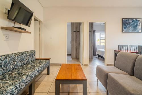 a living room with a couch and a table at ATKV Goudini Spa in Rawsonville