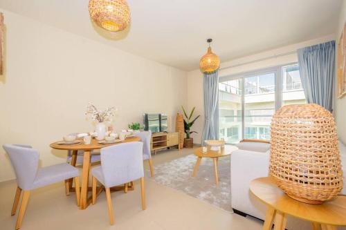 a living room with a dining room table and chairs at Seaside Serenity Apartment in Ras al Khaimah