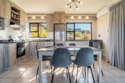 a kitchen with a table and four chairs at ATKV Goudini Spa in Rawsonville
