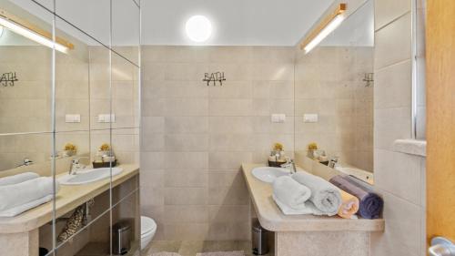 a bathroom with two sinks and a shower at Villa Nira by Villas Holiday in Barat