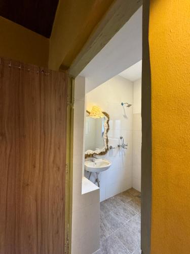a bathroom with a sink and a mirror in it at The Melo pomelo courtyard. ( Right in between Thamel and basantapur durbar square) in Kathmandu