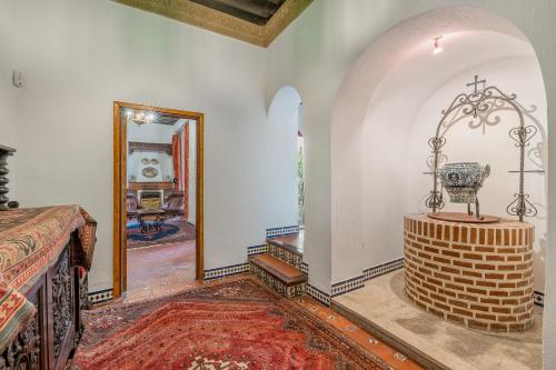 a room with a table and a mirror and a bed at Carmen San Andrés in Granada