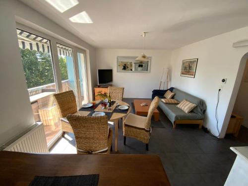 a living room with a couch and a table at Luminous apartment in Kehl near Strasbourg, conveniently located next to a tram stop with direct access to Strasbourg city centre in Kehl am Rhein
