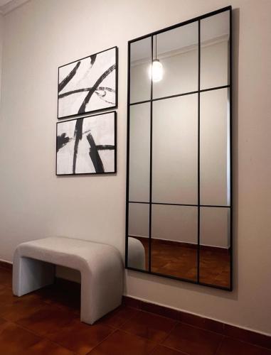 a room with a bench and a mirror at Oikiaegina in Aegina Town