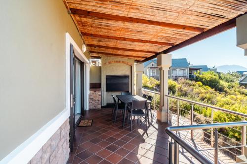a patio with a table and chairs on a balcony at ATKV Goudini Spa in Rawsonville