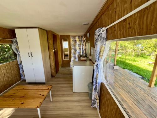 a living room of a tiny house with a wooden floor at Dom Uzdrowisko in Tolkmicko