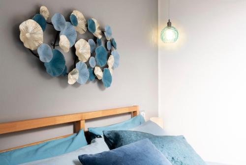a bedroom with a bed with blue pillows at The window to the sky in Ghirla