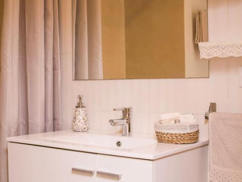 a white bathroom with a sink and a mirror at Little Venice apartment in Alboraya
