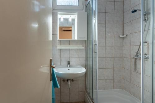 a bathroom with a sink and a shower at Apartman GREEN & BLUE in Novalja