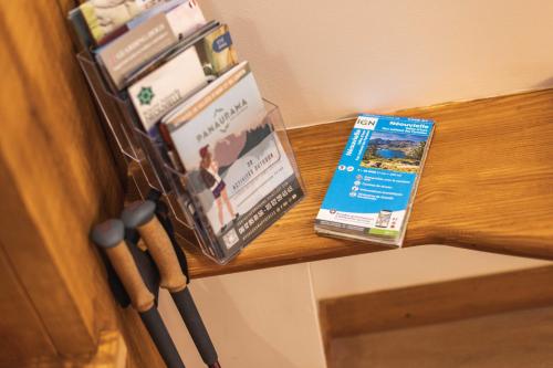 a bunch of books are sitting on a table at Le Rioumajou 1 - Grand T6 - Piscine - Centre St Lary in Saint-Lary-Soulan