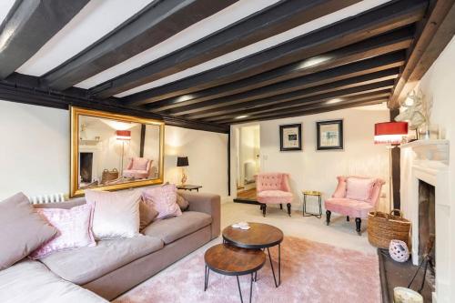 a living room with a couch and a table at Dorney Windsor Legoland 5 Star Stay for upto 14 guests in Dorney