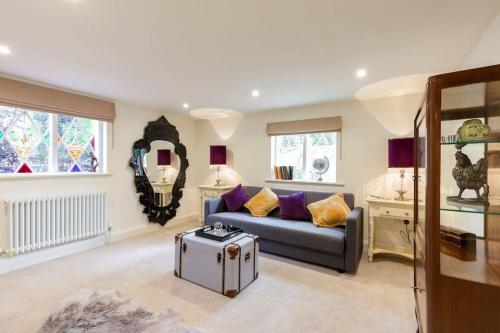 a living room with a couch and a table at Dorney Windsor Legoland 5 Star Stay for upto 14 guests in Dorney