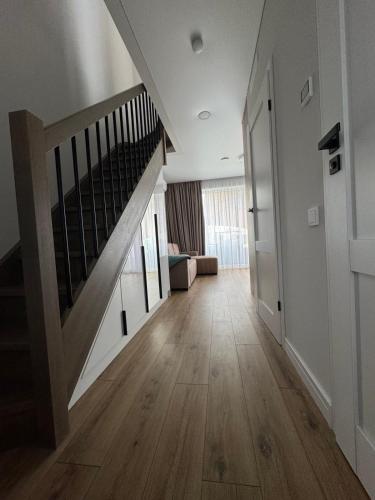 a hallway with a staircase in a house at SeasideSpa appartment Jakuzzi Swimming pool in Palanga